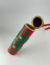 Red and green leather cylindrical case with gold button details and a gold-rimmed open lid